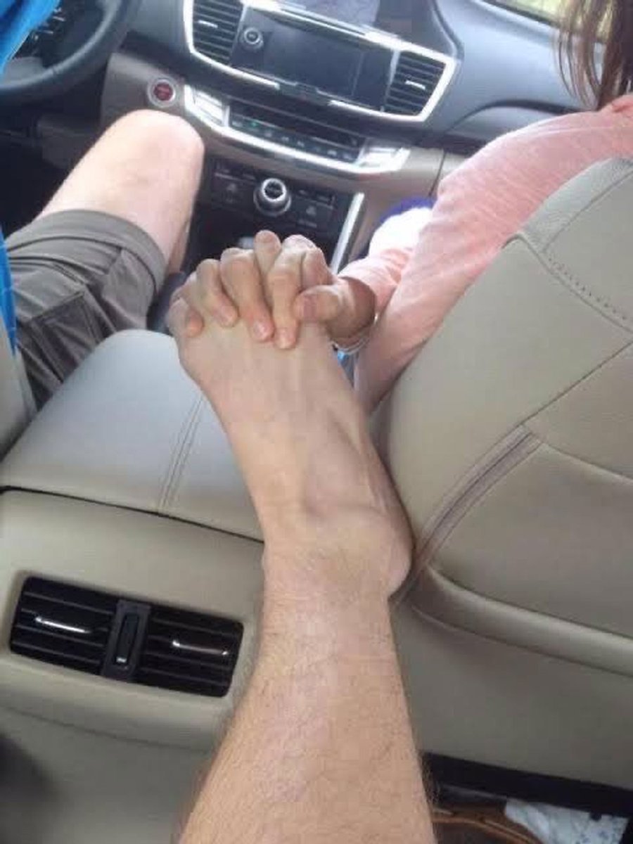 Муж держит ноги. Рука в руке в машине. Держаться за руки в машине. Ноги парней. Держась за руки в машине.